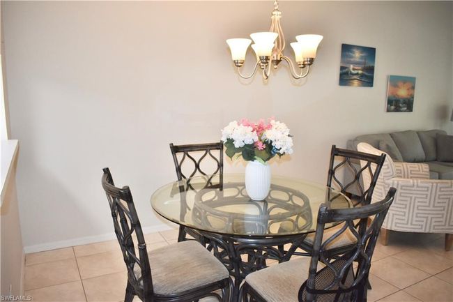 Tiled dining space with a chandelier | Image 7