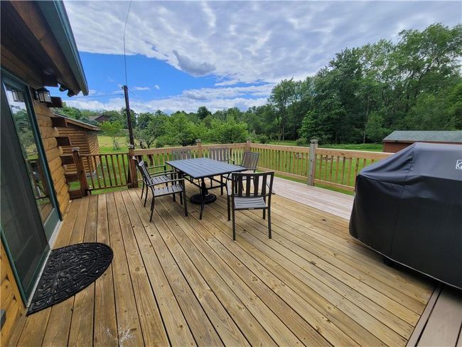 Wooden terrace featuring a grill | Image 21