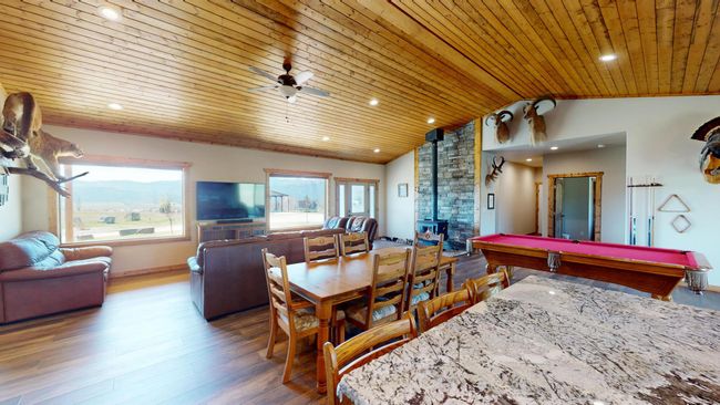 Recreation room with a wood stove, recessed lighting, wooden ceiling, lofted ceiling, and wood finished floors | Image 11