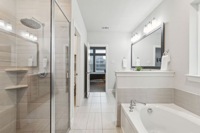Ensuite bathroom featuring a shower stall, a garden tub, tile patterned flooring, and double vanity | Image 14