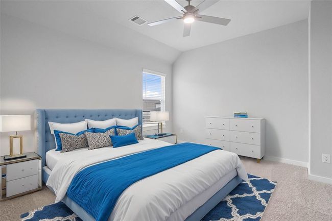 Secondary bedroom features plush carpet, custom paint, ceiling fan with lighting and a large window with privacy blinds. | Image 15
