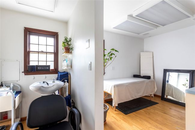 Bedroom featuring attic access, wood finished floors, and a sink | Image 12