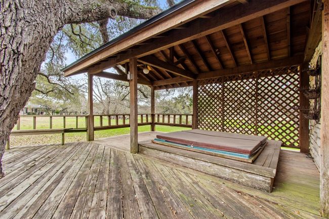 Wooden terrace with a covered hot tub | Image 34