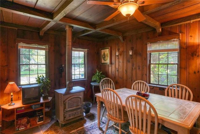 Dining area featuring wood ceiling, beam ceiling, and wooden walls | Image 9