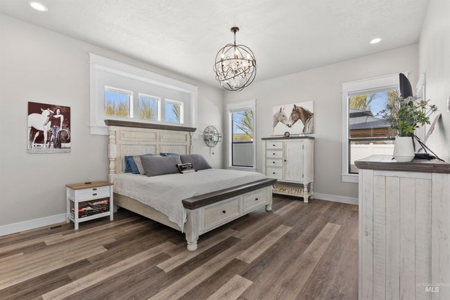 Bedroom featuring a chandelier, dark wood-type flooring, and recessed lighting | Image 22