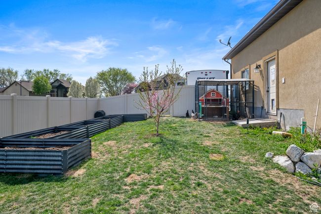 View of yard featuring a vegetable garden and a fenced backyard | Image 39