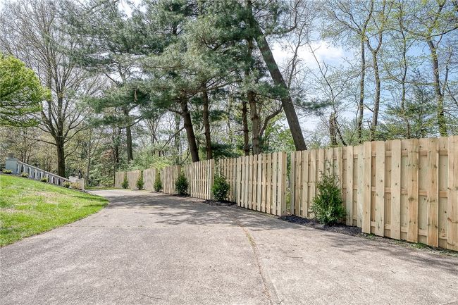Shadowbox fence lines the driveway. | Image 44