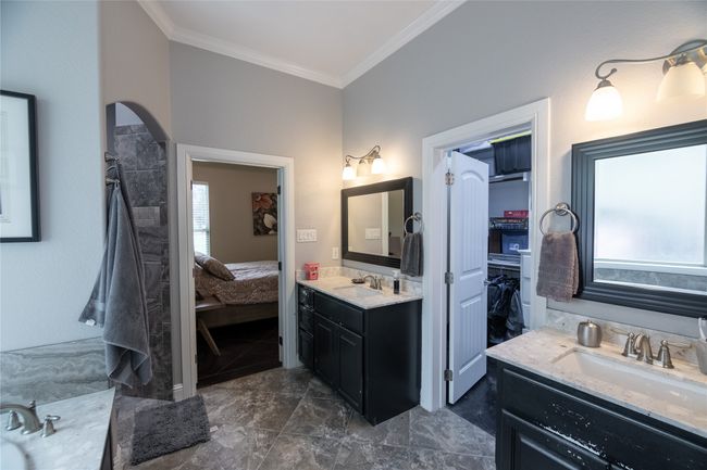 Ensuite bathroom featuring crown molding, two vanities, and marble finish floors | Image 21