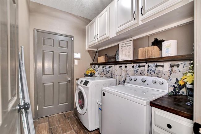 Spacious utility room with direct garage access. | Image 27