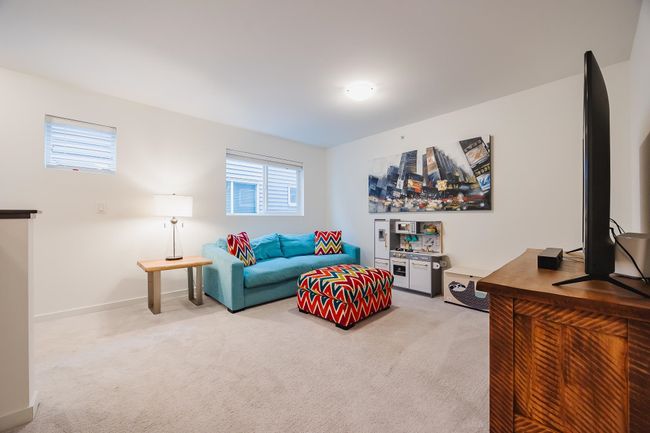 Bedroom featuring vaulted ceiling, ensuite bathroom, ceiling fan, light carpet, and baseboards | Image 16