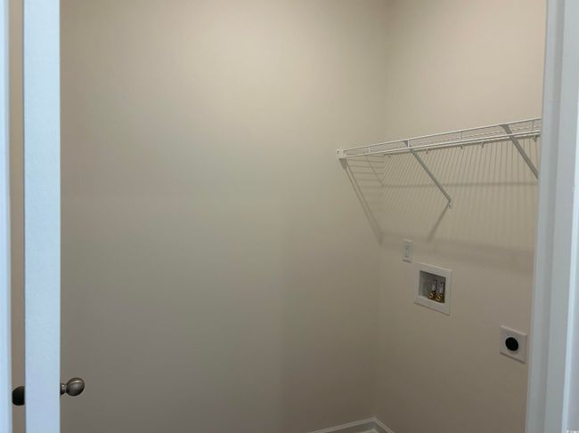 Washroom featuring hookup for an electric dryer, hookup for a washing machine, and baseboards | Image 16