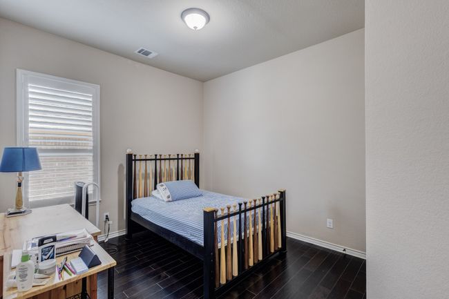 Bedroom with dark wood finished floors and baseboards | Image 21