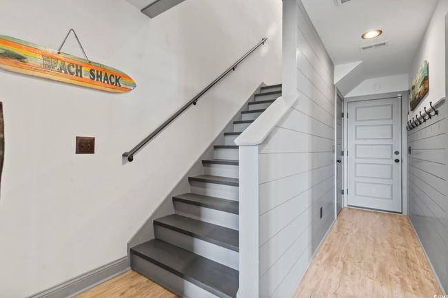 Stairway featuring wood finished floors and visible vents | Image 24