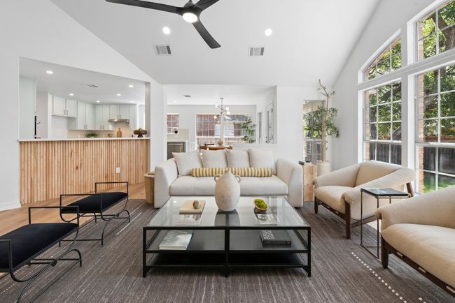 Flooded with natural light, the spacious living room features beautiful arched windows that bring the outdoors in and create an airy, inviting atmosphere | Image 12