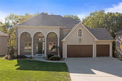 View of front of house with a front yard and a garage | Image 1