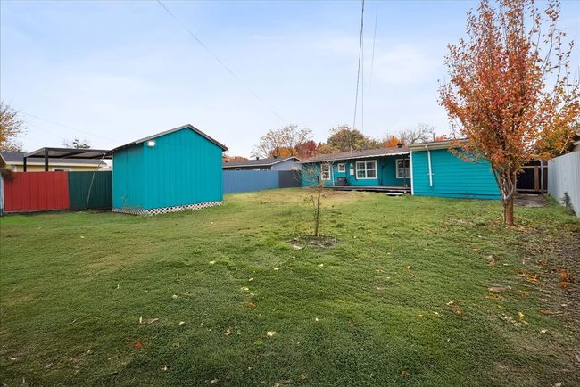 Fenced backyard featuring a storage shed | Image 21