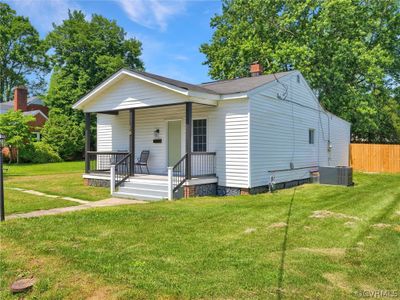 View of front of home featuring a front yard and central air condition unit | Image 1