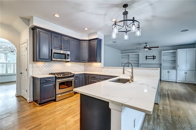 Updated kitchen with stainless steel appliances and brushed bronze hardware. | Image 13