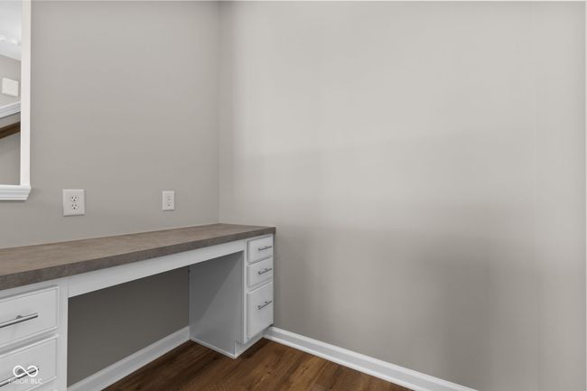 Extra office off the kitchen featuring built in desk and dark wood finished floors | Image 12