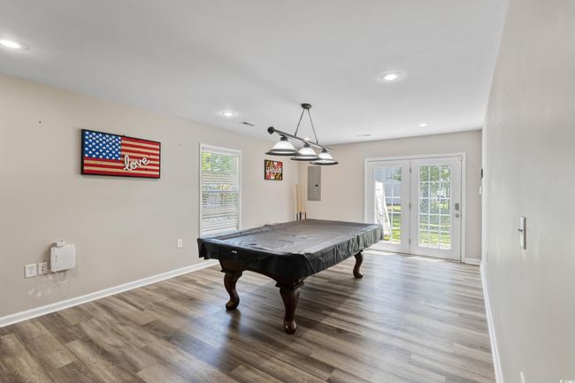 Recreation room with healthy amount of natural light, wood finished floors, recessed lighting, and billiards table | Image 16