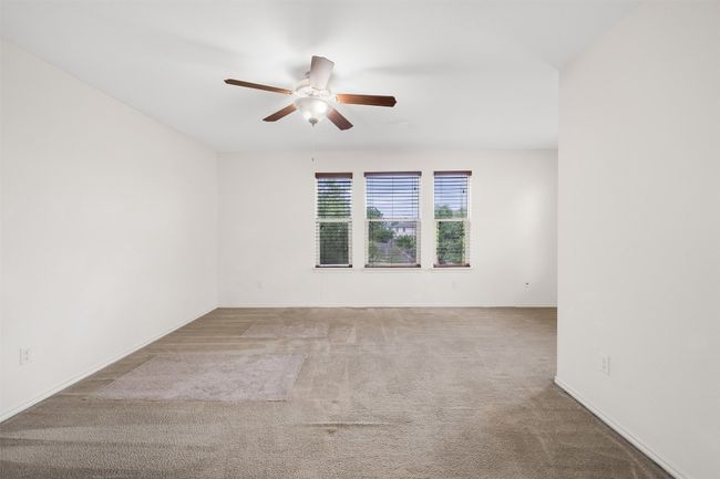 Unfurnished room with ceiling fan, carpet floors, and baseboards | Image 20