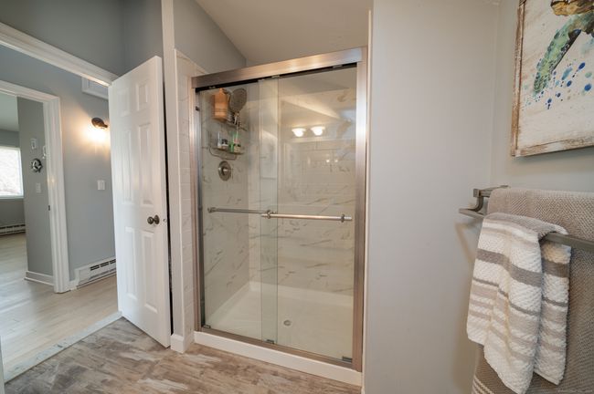 Remodeled hall bath has a large walk-in shower | Image 17