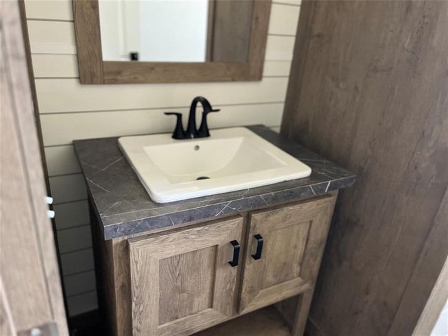 Guest Vanity. This bath offers a tub shower combo. | Image 15
