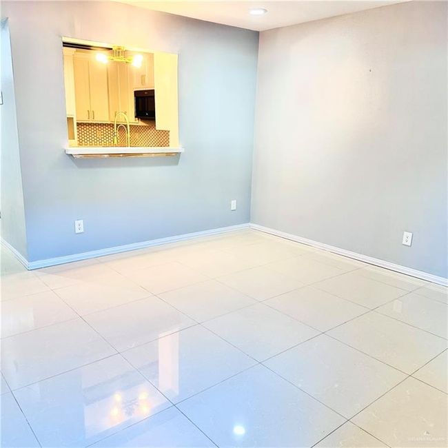 Unfurnished living room featuring baseboards and light tile patterned flooring | Image 10