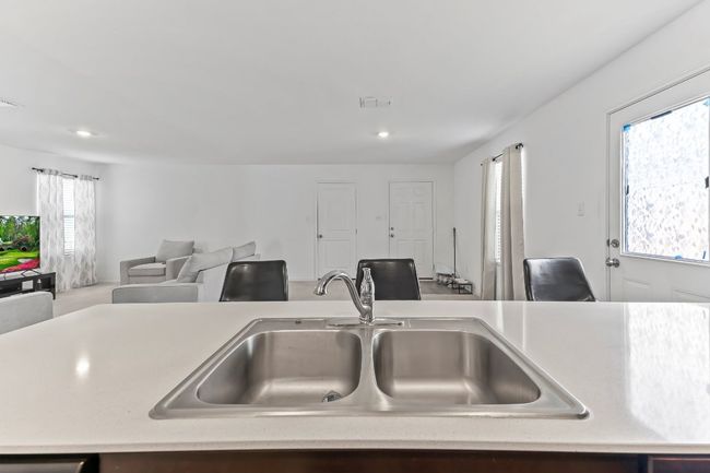 Kitchen featuring light countertops, open floor plan, and recessed lighting | Image 17