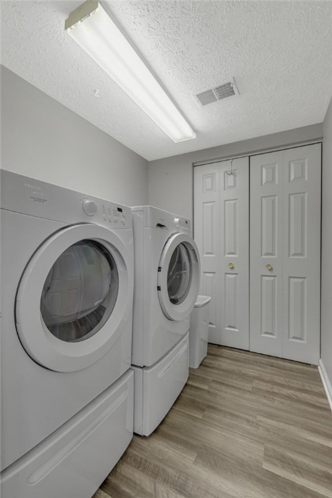 This laundry area is located just off the kitchen. From here you enter the large 2 stall garage. Shows the ease of accessing your home from the garage. W/D stay with the property as well. | Image 20