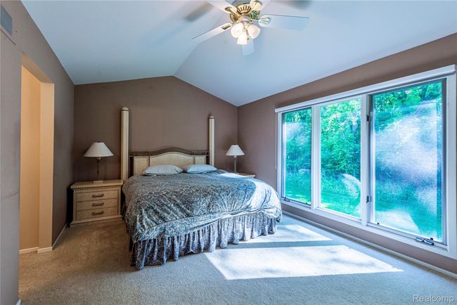 Primary bedroom suite; large windows bring outdoors | Image 16