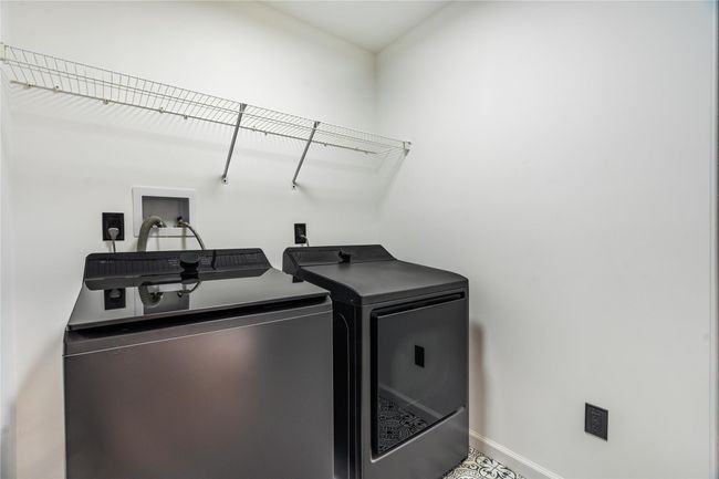 Laundry room with washing machine and dryer, baseboards, and laundry area | Image 38