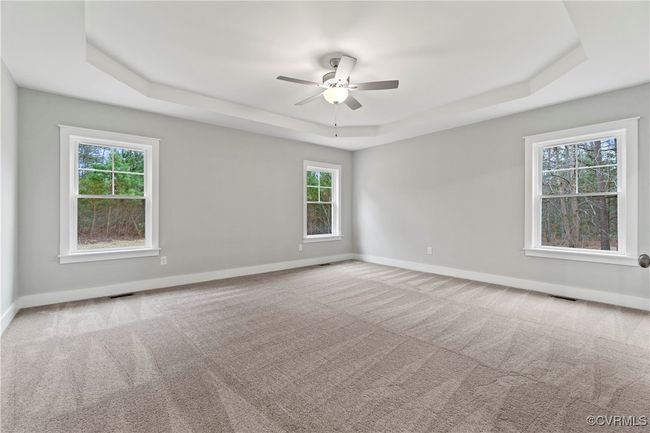 Photo represents the plan, not the actual home. Design selections may vary. The first-floor primary suite includes a walk-in closet and an ensuite bath featuring a double vanity, a tiled walk-in shower, a water closet, and a linen closet. | Image 5