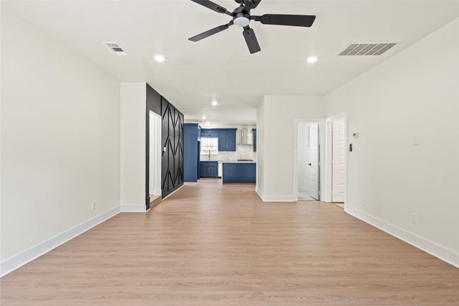 Unfurnished living room featuring ceiling fan, recessed lighting, and light wood-style flooring | Image 10