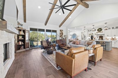 Step inside to find an open-concept main floor where the high-vaulted, wood-beamed ceilings create an airiness you’ll love | Image 2