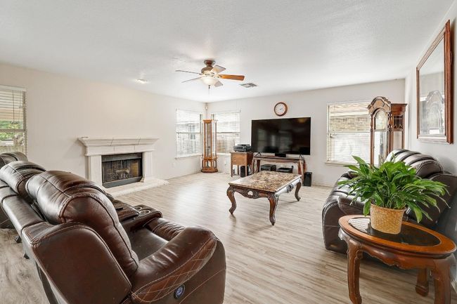 Large living room with no carpet and a lovely gas fireplace. | Image 4