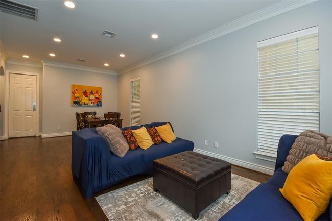 Formal living + dining room with hardwood floors, recessed lighting, and a neutral color scheme | Image 4