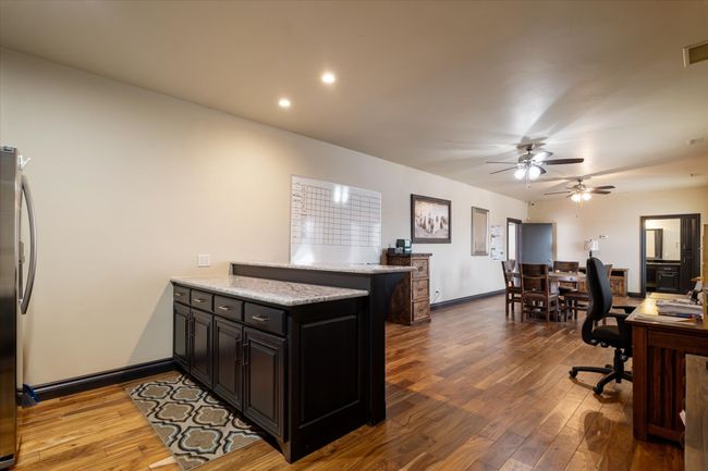 Office with wood-type flooring and ceiling fan | Image 15