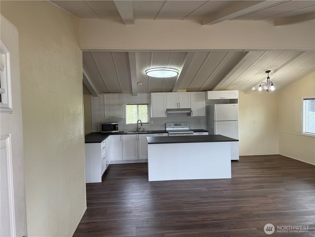 Living room facing kitchen with vaulted ceiling | Image 21