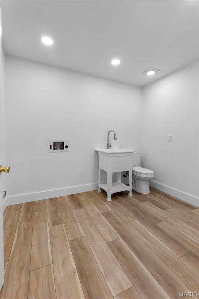Laundry/half-bath with light hardwood/wood-style floors | Image 10