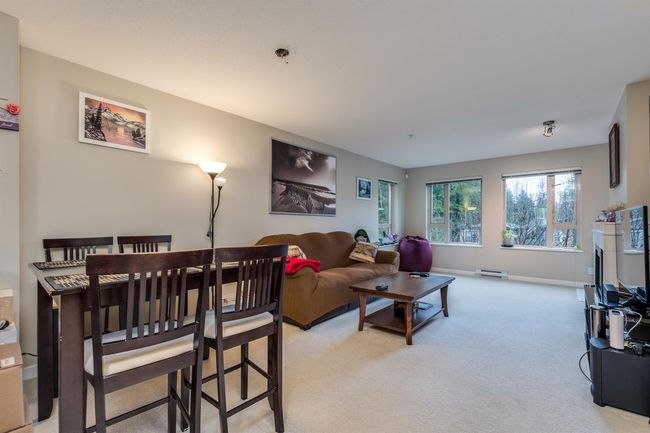 Living room with light carpet, baseboards, and baseboard heating | Image 8