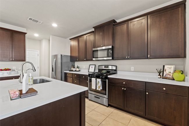 Kitchen featuring stainless steel appliances, light countertops | Image 7