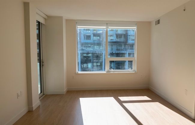 Spare room featuring light wood finished floors and baseboards | Image 8