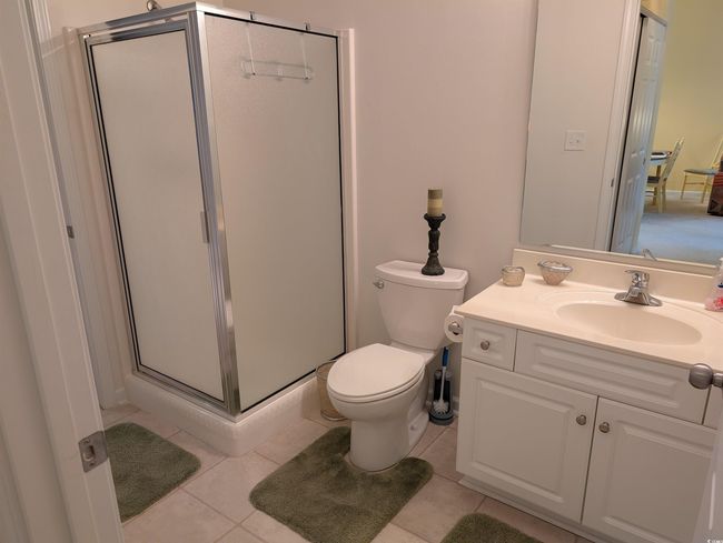 Bathroom featuring vanity, toilet, tile patterned floors, and a shower stall | Image 13