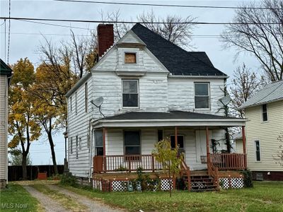 View of front of house featuring a porch and a front lawn | Image 1