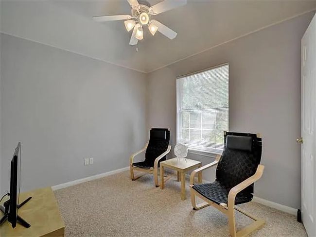 Living area with carpet floors and a ceiling fan | Image 20
