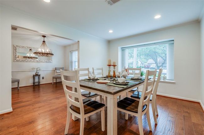 Spacious Dining Room to the front of the home with recessed lighting, beautiful recent window with 2 in blind, engineered hard wood floor, crown molding | Image 4
