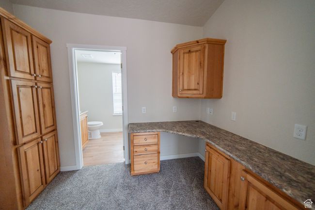 Unfurnished office with built in study area, baseboards, and carpet | Image 35