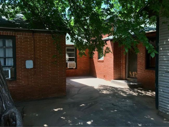 View of side of home with a patio area and brick siding | Image 17