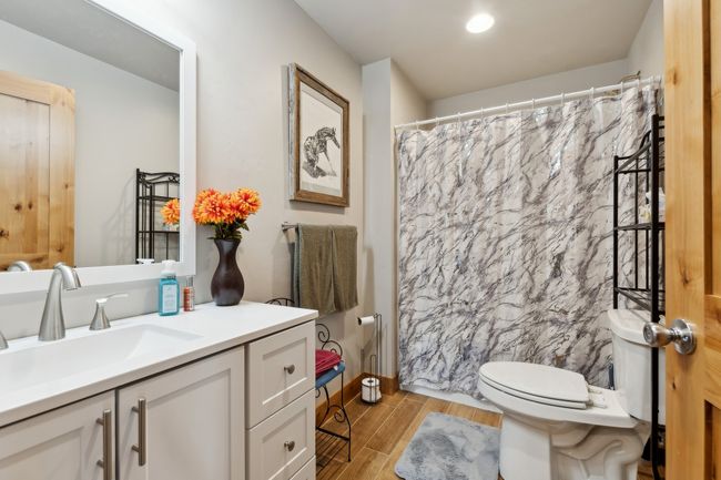 Bathroom with toilet, vanity, and walk in shower | Image 47